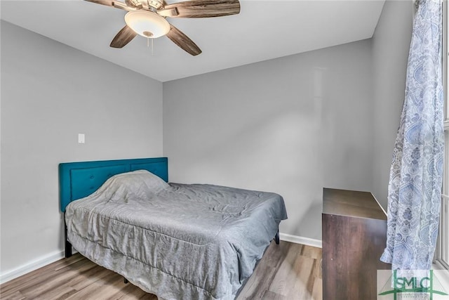 bedroom with hardwood / wood-style flooring and ceiling fan