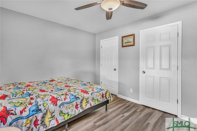 bedroom with hardwood / wood-style flooring and ceiling fan