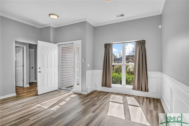 unfurnished bedroom with light hardwood / wood-style floors and crown molding