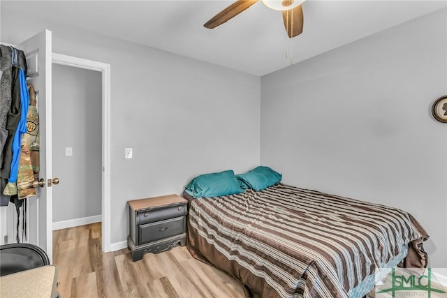 bedroom with light hardwood / wood-style flooring and ceiling fan