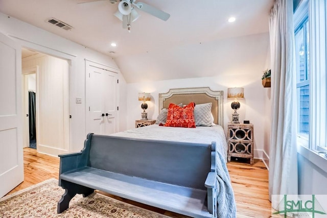 bedroom with multiple windows, vaulted ceiling, and light hardwood / wood-style floors