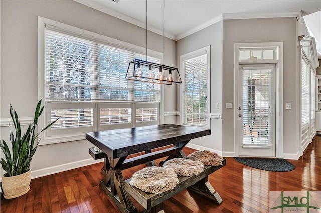 dining space with ornamental molding and dark hardwood / wood-style floors