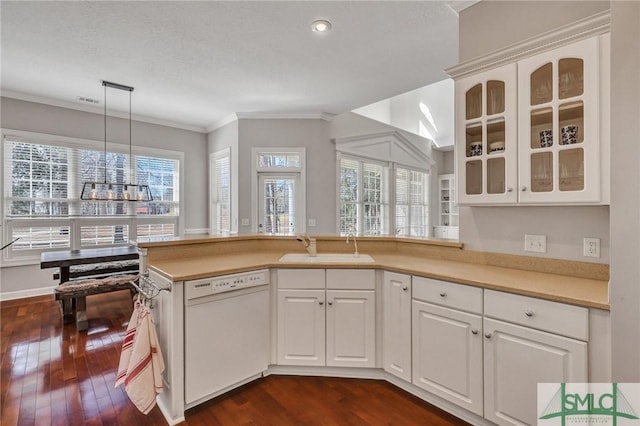 kitchen with sink, white cabinetry, white dishwasher, dark hardwood / wood-style flooring, and hanging light fixtures