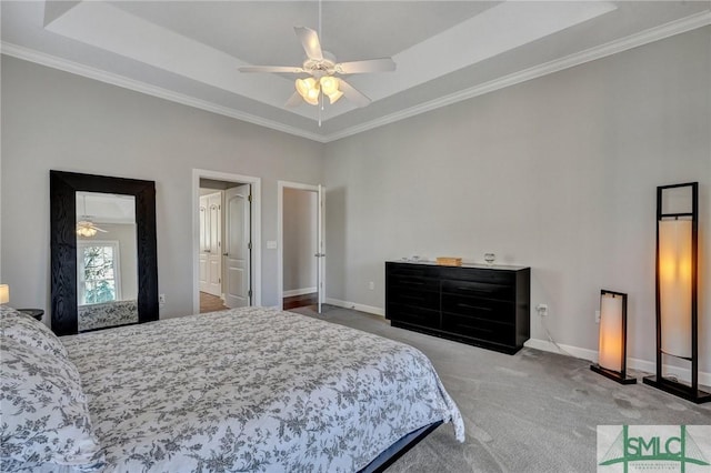 bedroom featuring a tray ceiling, crown molding, carpet flooring, and ceiling fan