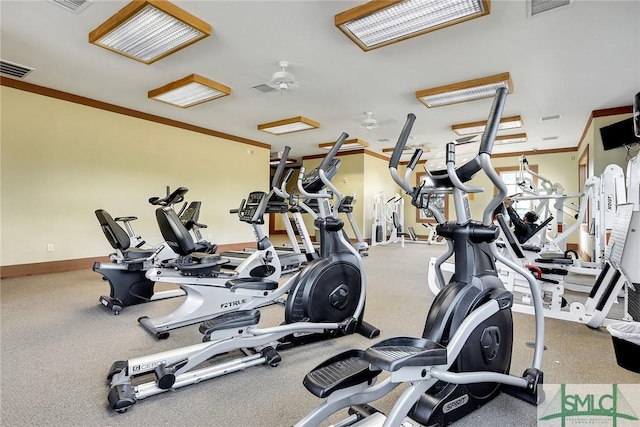 exercise room featuring crown molding