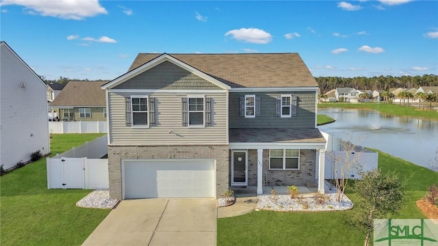 view of front facade featuring a garage, a water view, and a front yard