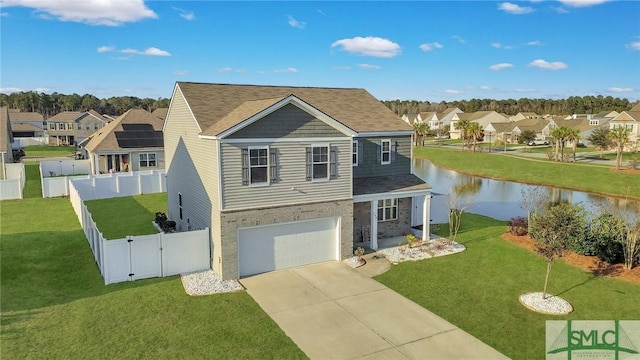 view of front of property featuring a water view, a front lawn, and a garage