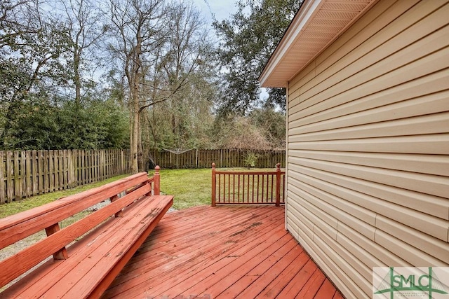 wooden deck with a lawn