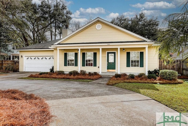 view of front of property featuring a front lawn, a porch, and a garage