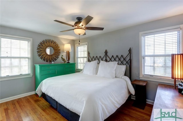 bedroom featuring ceiling fan and dark hardwood / wood-style floors