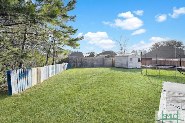 view of yard featuring a storage unit and a trampoline