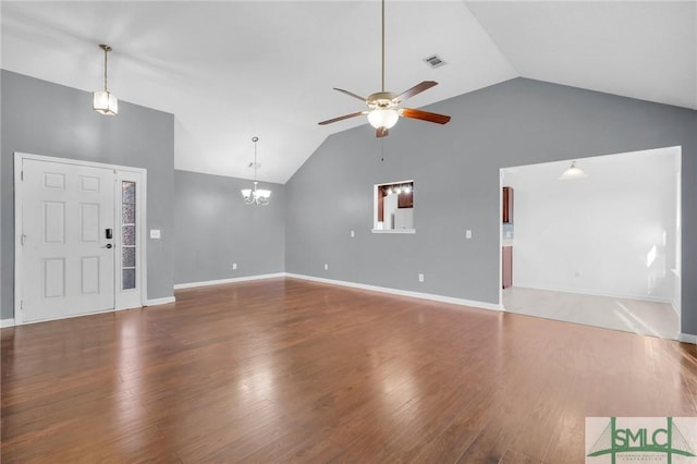 unfurnished living room with ceiling fan with notable chandelier, high vaulted ceiling, and wood-type flooring