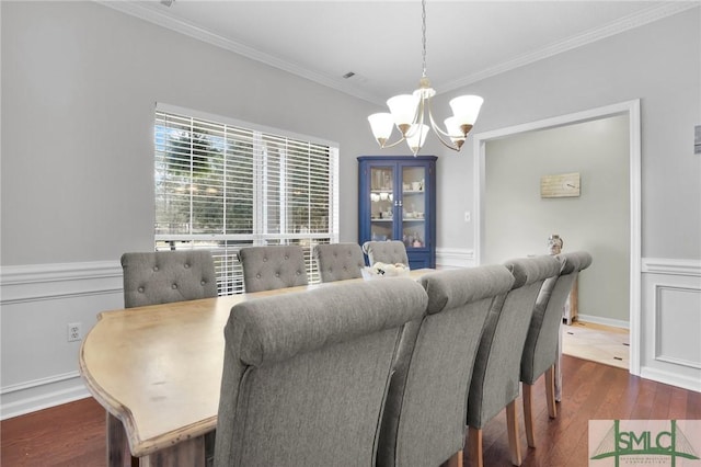 352 Harbour Ln, Richmond Hill, GA 31324 - dining area featuring dark wood-type flooring, ornamental molding, baseboards, and an inviting chandelier