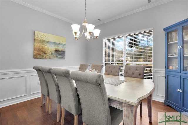 352 Harbour Ln, Richmond Hill, GA 31324 - dining space with ornamental molding, a wainscoted wall, a notable chandelier, and dark wood finished floors