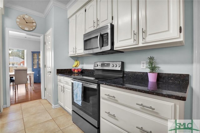 352 Harbour Ln, Richmond Hill, GA 31324 - kitchen featuring stainless steel appliances, white cabinets, light tile patterned flooring, and ornamental molding