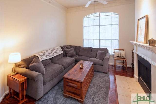 living room with crown molding, ceiling fan, and wood-type flooring