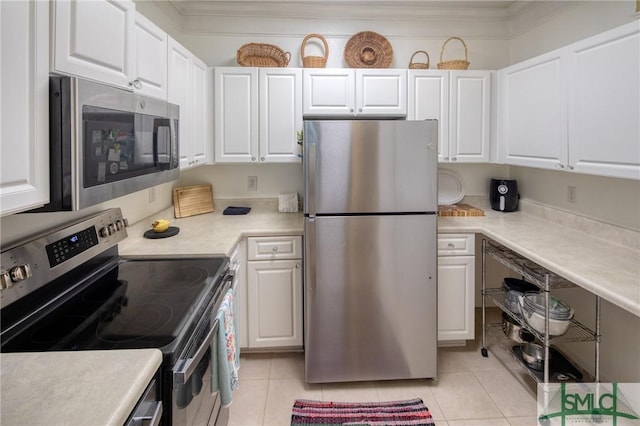 kitchen featuring white cabinets, appliances with stainless steel finishes, and light tile patterned floors