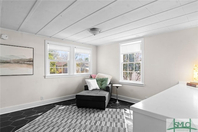 sitting room with dark tile patterned flooring and baseboards