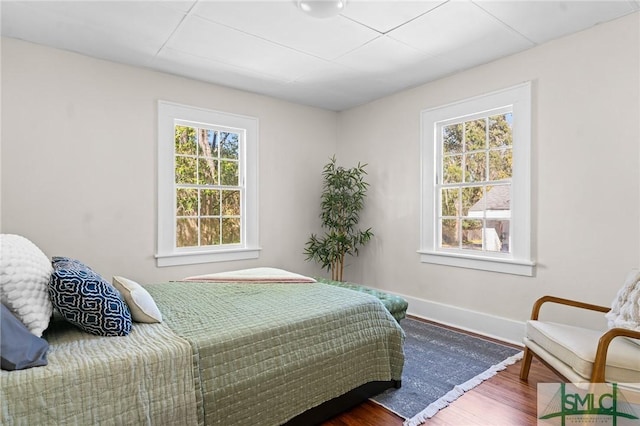 bedroom featuring baseboards and wood finished floors