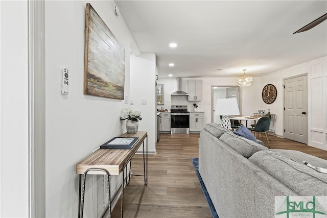 living area featuring dark wood-type flooring and recessed lighting