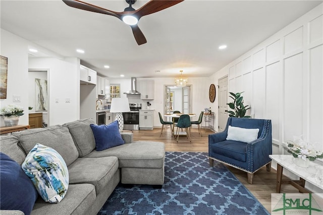 living room featuring wood finished floors, recessed lighting, and ceiling fan