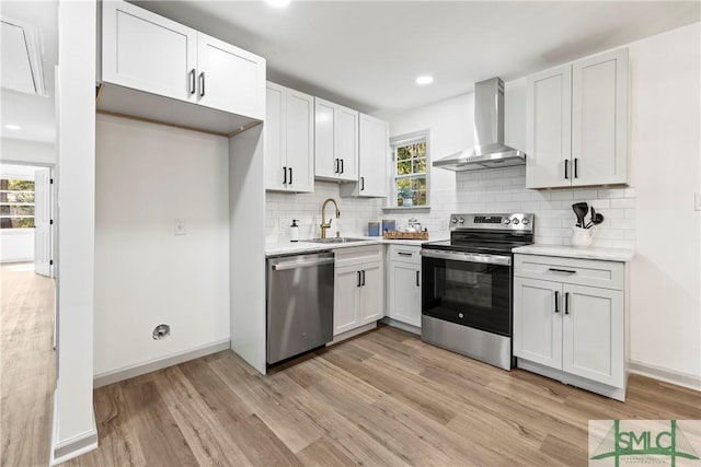 kitchen with appliances with stainless steel finishes, white cabinetry, and light countertops