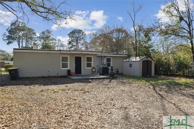 back of house featuring a patio area, central AC unit, and a storage shed