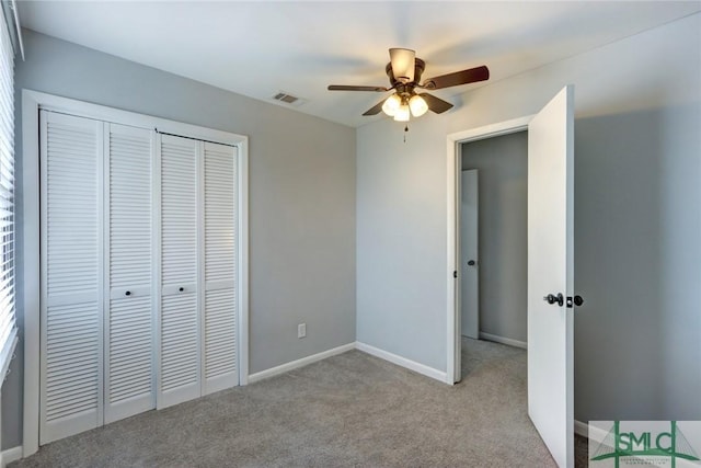 unfurnished bedroom featuring light colored carpet, a closet, visible vents, and baseboards