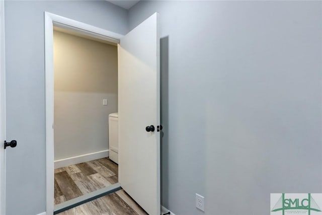 bathroom with baseboards and wood finished floors