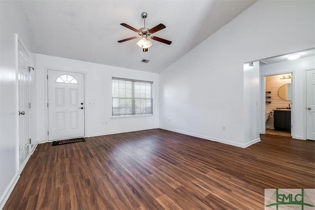 foyer entrance with visible vents, dark wood finished floors, baseboards, high vaulted ceiling, and ceiling fan