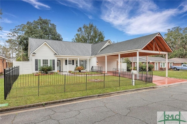 ranch-style house with roof with shingles, driveway, a fenced front yard, an attached carport, and a front yard