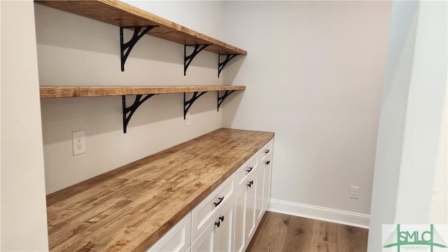 interior space with dark wood finished floors and baseboards