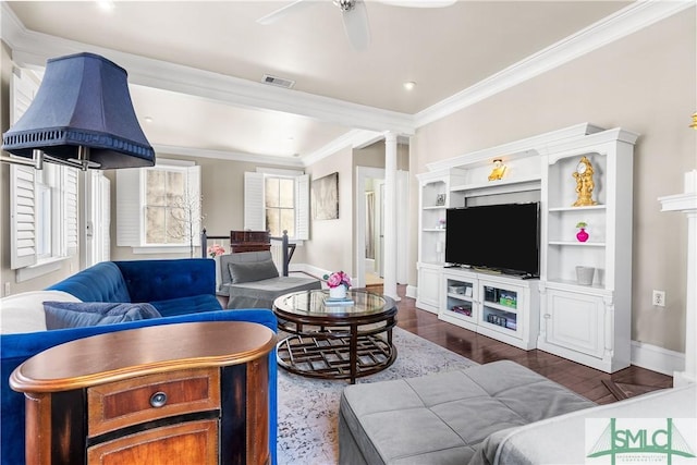 living area with dark wood finished floors, crown molding, visible vents, a ceiling fan, and baseboards