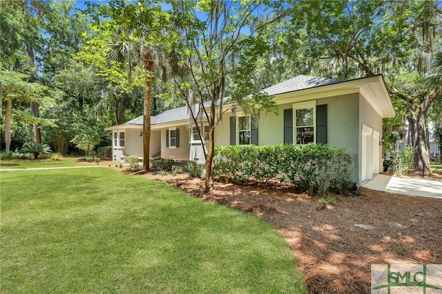 single story home with stucco siding, a shingled roof, and a front yard