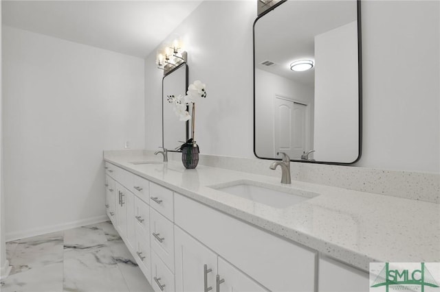 full bath featuring marble finish floor, double vanity, a sink, and visible vents