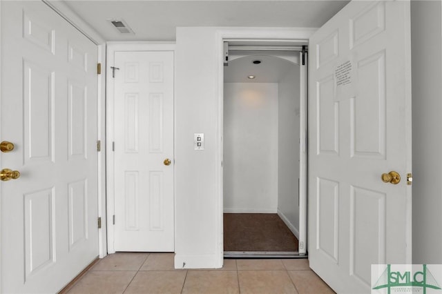 interior space featuring visible vents and light tile patterned floors