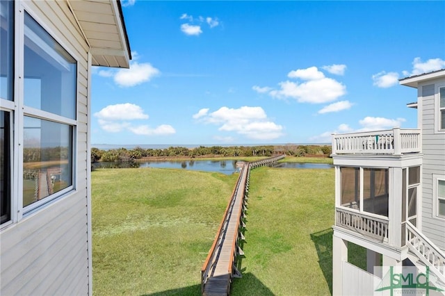 view of yard with a water view and a sunroom