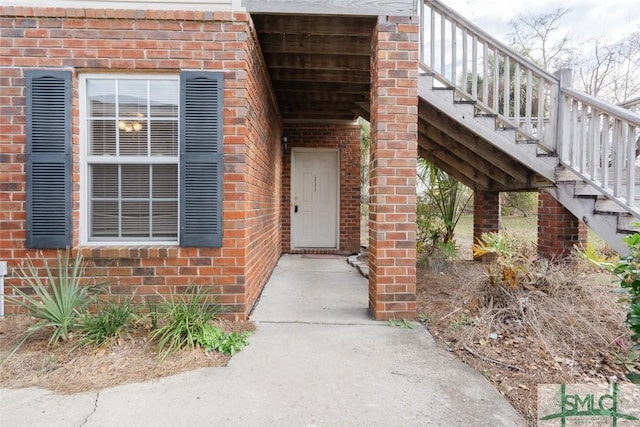 view of exterior entry with brick siding