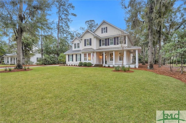 view of front of property featuring a standing seam roof, metal roof, a front lawn, and a porch