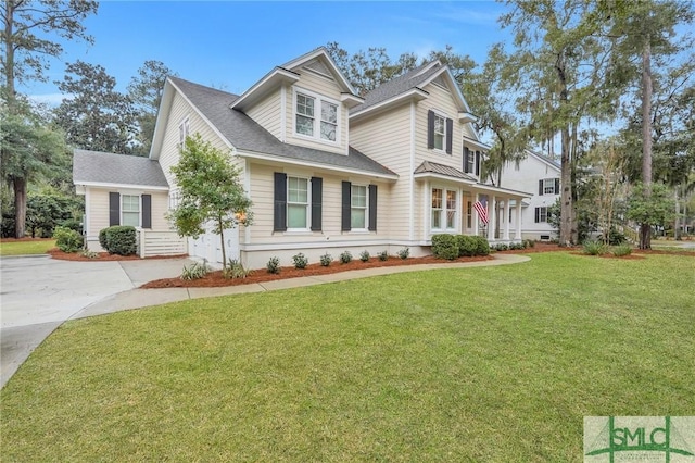 view of front of house with driveway and a front lawn