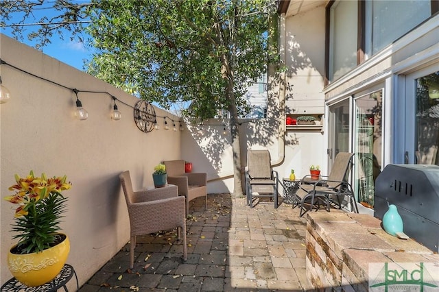 view of patio / terrace with a fenced backyard and a grill