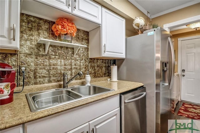 kitchen featuring light countertops, tasteful backsplash, a sink, and white cabinets