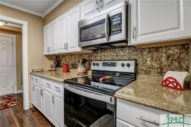 kitchen with appliances with stainless steel finishes, white cabinets, ornamental molding, and tasteful backsplash