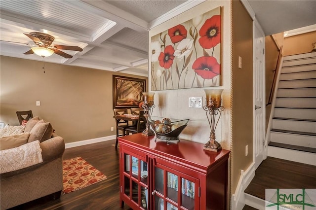 interior space with dark wood-type flooring, coffered ceiling, baseboards, stairs, and beam ceiling