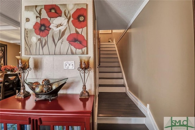 stairway featuring baseboards and crown molding