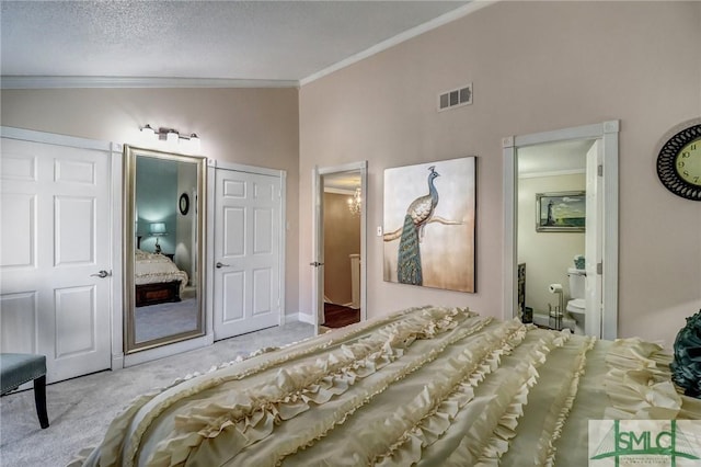 bedroom with a textured ceiling, visible vents, carpet flooring, and ornamental molding