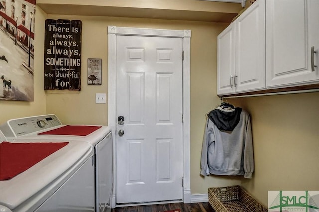 washroom with dark wood-style floors, cabinet space, and washer and dryer