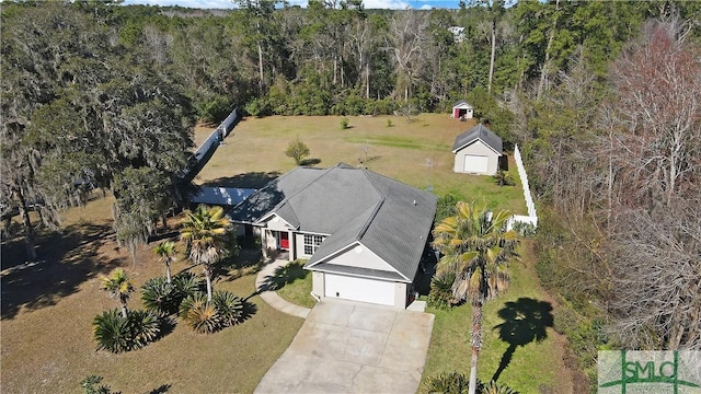 birds eye view of property featuring a view of trees