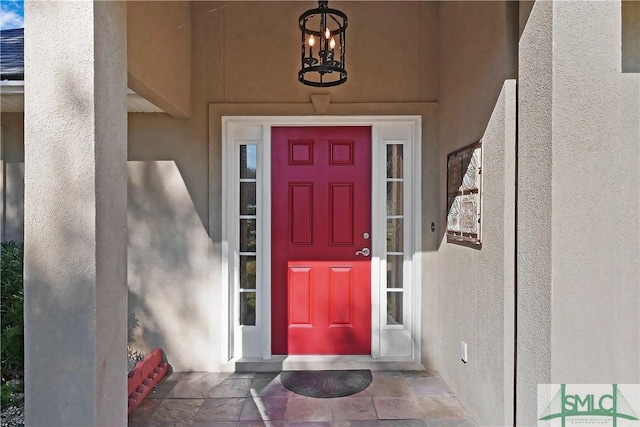 entrance to property with stucco siding