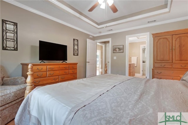 bedroom with visible vents, a raised ceiling, connected bathroom, ceiling fan, and ornamental molding